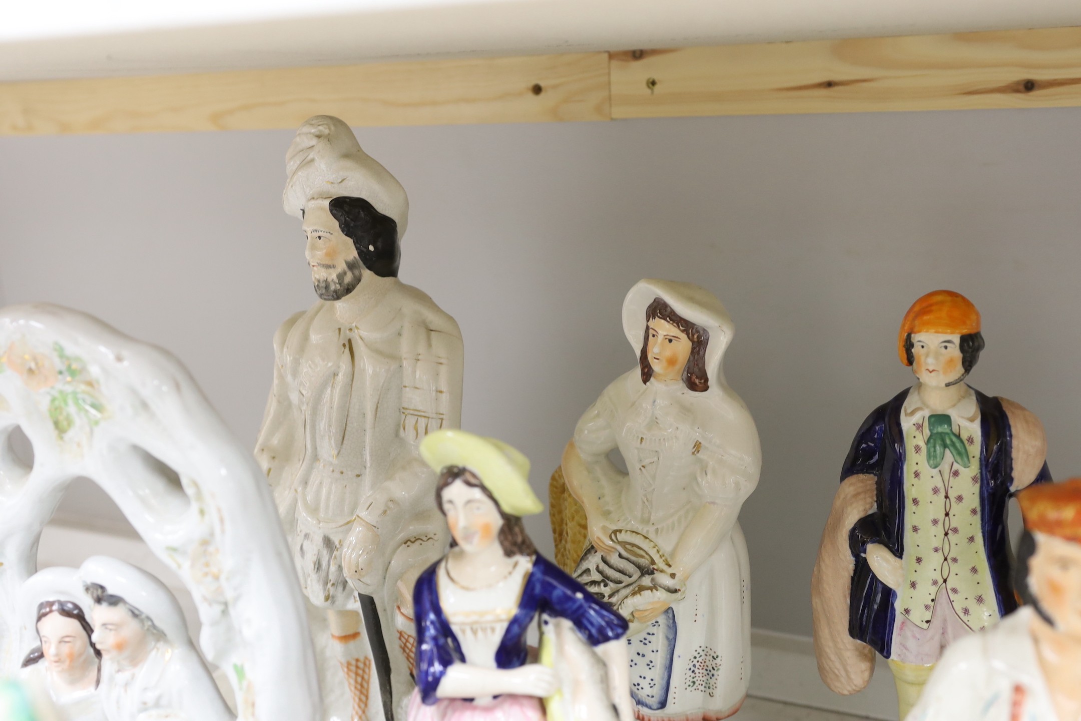 A group of Staffordshire pottery and porcellaneous figures and groups, The tallest 42 cm